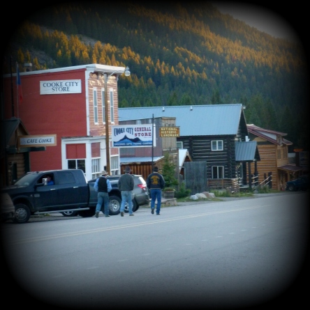 Note the 3 men in cowboys boots & hats.  This is Main Street (basically the ONLY street) of Cooke City, MT, just outside the NE entrance of Yellowstone NP.