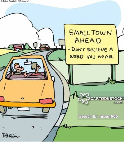 Sign reads: 'Small town ahead - don't believe a word you heard.'